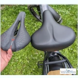 Ein breiter und ein schmaler Fahrradsattel zum Vergleich nebeneinander